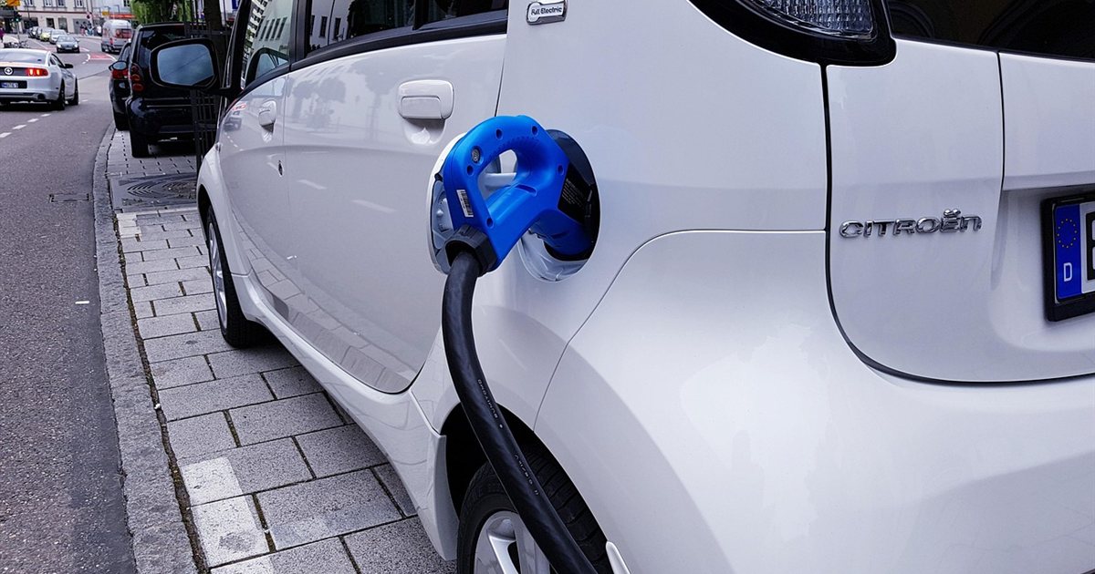 An electric car plugged into a charging station