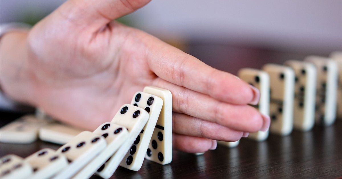Falling dominoes representing a collapsing scheme