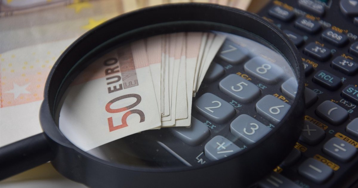 Calculator and money representing the cost of borrowing