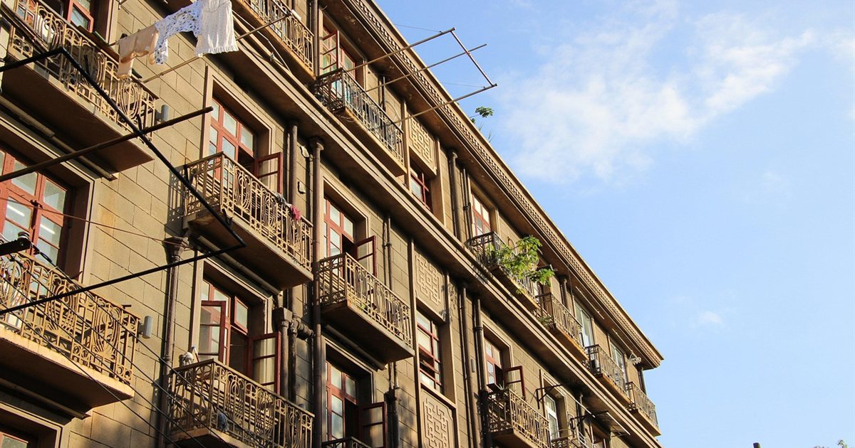 A worn apartment building exterior in need of repair
